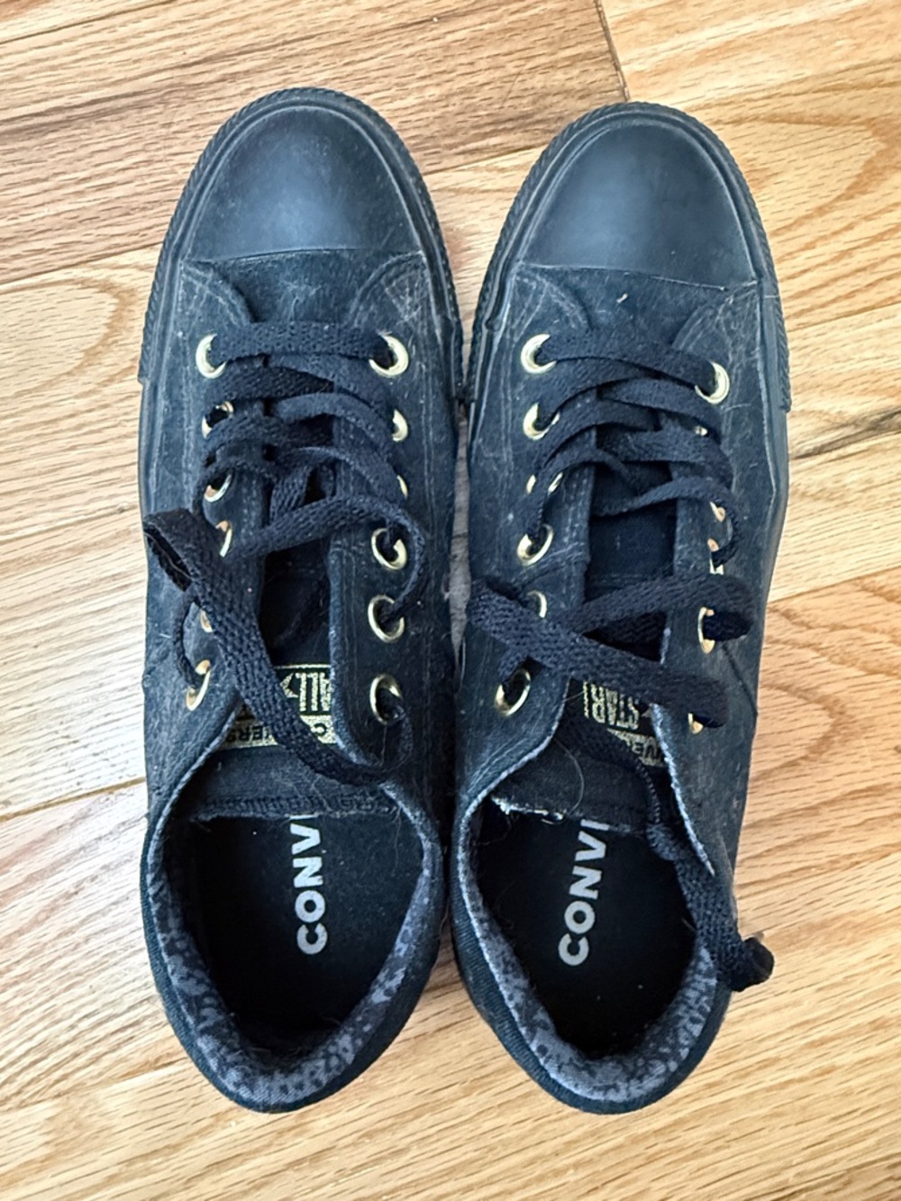 Worn Converse Black Low-Top Sneakers with Gold Eyelets